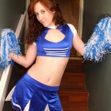 Redheaded teen Ruby dresses up as a cheerleader then strips