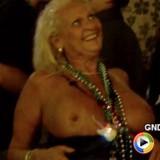 Old lady flashes her big tits to the crowd for beads at Mardi Gras